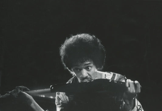 Jimi Hendrix with his guitar by Claude Gassian